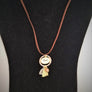 Full 6er necklace on a brown cord on a black backdrop.