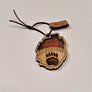 Single Adirondack Park-shaped wood/fabric ornament on a white background. Red plaid fabric shows through the top half with ADIRONDACK etched above the image of a plaid bear paw showing through the bottom center.