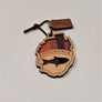 Single Adirondack Park-shaped wood/fabric ornament on a white background. Red plaid fabric shows through the top half with ADIRONDACK etched above the image of a plaid fish showing through the bottom center.