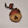 Single Adirondack Park-shaped wood/fabric ornament on a white background. Red plaid fabric shows through the top half with ADIRONDACK etched above the image of an Adirondack chair in the bottom center.