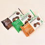 3 packages of peanut butter cups top: dark chocolate in brown and white package; middle milk chocolate peanut butter cups with sea salt in green and white packaging, bottom: milk chocolate peanut butter cups in amber and white packing.