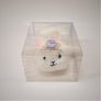 Furry Boo Boo Bunny in its clear plastic packaging box. The black eyes, white and black noes, and pale pink ears can be seen through the packaging.