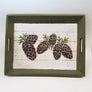 Green trim-edged tray with white base and 6 pine cones depicted on surface.