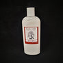 Single bottle of Rustic Cedar Goat Milk Lotion standing straight up. White liquid can be seen through clear plastic around the rectangular label in the center. The label has a rust-colored border with the black tree and goat logo in the center. Above the logo is the text Rustic Cedar Goat Milk Lotion and below in script Lavender with 8 fl.oz. /236 ml below that.