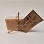 Single bar of Goat's Milk Scotch Pine soap standing upright with beige twine circling the center holding the beige label.