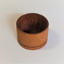 Darker wood end grain bowl standing straight up on a white background. The inside of the bowl looks very dark from this perspective.