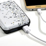Closed over of the rfid wallet with cord plugged in to it and to a phone.