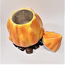 Campfire cookie jar open to show white ceramic inside with triangular-like orange top resting on the right bottom.