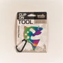 Clip-on Fish Tool in packaging. Stainless steel fish appears with shades of purple on the right side next to the black and silver carabiner clip.