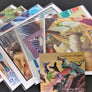 Collage cards fanned out altogether. On top apples, pumpkin, books and antique fabrics under artist Cindy Ayres card