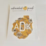 Decal of the Adirondack Park boundaries in yellow floral with white ADK lettering centered in the design.