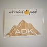 Adirondack mountain decal in wood grain pattern with white ADK lettering printed at the base of the mountain