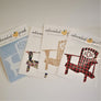 Fanned out display of Adirondack chair decals in white, floral, wood grain, and buffalo plaid with an oval in top of chair with ADK lettering showing on some of the chair decals.