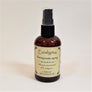 Standing brown bottle of Eucalyptus therapeutic spray with pale yellow label facing forward.