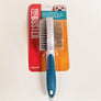 Two-sided brush with white plastic backing on a blue handle in red and gold packaging