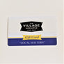 Village Mercantile Gift Card photographed flat. Blue border on bottom with words: "LOCAL MATTERS"