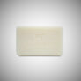 Unscented DIonis Goat Milk Soap out of box standing flat. Image of a goat and DIONIS type can be scene faintly etched into the soap.
