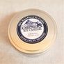 Close up of top of tin cover of 6-ounce Lakehouse soy candle