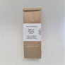 Single brown paper bag on a white backdrop. A while label in the center has black type saying White Birch Botanicals with the lettering Natural Laundry Soap in the center and more washing details printed below.