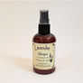Standing brown bottle of Lavender Spritzer with pale yellow label facing forward.