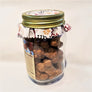 Side, standing view of the clear part of the mason jar showing the maple dog biscuits inside with the fabric-lined top of jar also visible.
