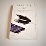 Boxed package of the rfid powerbank wallet. White box with black type and color photos of phone and wallet.