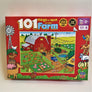 Puzzle cover of 101 things to spot on the farm with red border and a red barn surrounded by colorful fields and farm animals.