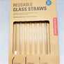 Box of reusable glass straws with the straws and cleaner showing through the packaging window.