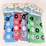 Four Skoy dishtowels fanned out with package label on top.  Each has a circle pattern with different designs within the white and black circles. Left to right: light blue, red, pale gray, light green