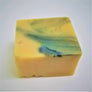 Pale yellow square soap bar with blue marbled top.