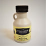Half-pint-size maple syrup jug. Solid jug with handle on the left, black screw top and The Village Mercantile label bottom, mid-section.