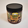The Dark Side of the Peanut gourmet peanut butter in its plastic jar with a black screw lid. Chipmunks and forest are featured on the label surrounding the type.