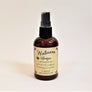 Standing brown bottle of Wellness Spritzer with pale yellow label facing forward.