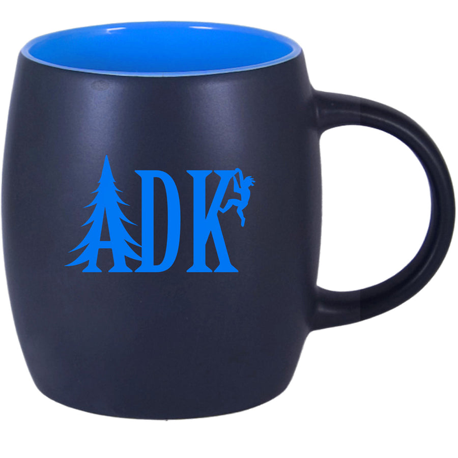 Mug with ADK lettering in sky blue with the A looking like a pine tree and a climber hanging off the K. Inside of mug showing same blue as the lettering.