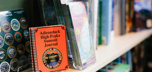 Hiking books, hiking stickers and hiking maps of the Adirondacks on the shelves at the Village Mercantile department store in Saranac Lake.
