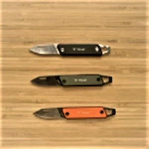 Three knives displayed open on a wood background. Orange handle in front; charcoal handle center; black handle on top.