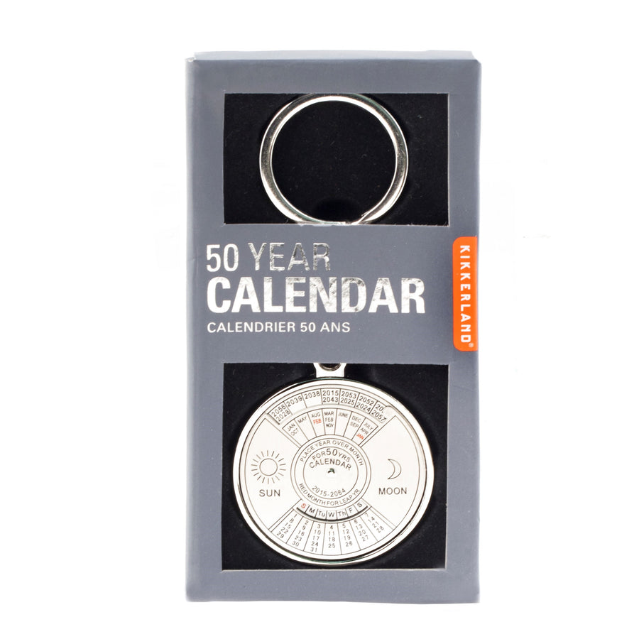 Silver calendar key ring in its gray packaging box. 50-year calendar with al of the numbers, months, years and sun and moon showing through