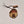 Single Adirondack Park-shaped wood/fabric ornament on a white background. Red plaid fabric shows through the top half with ADIRONDACK etched above the image of a plaid bear paw showing through the bottom center.