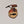 Single Adirondack Park-shaped wood/fabric ornament on a white background. Red plaid fabric shows through the top half with ADIRONDACK etched above the image of a plaid fish showing through the bottom center.