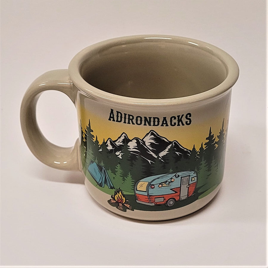 A single off-white mug with the handle to the left. The word ADIRONDACS printed in black or dark green above the image of snow-capped mountains, evergreens and blue tent, campfire and camper van.