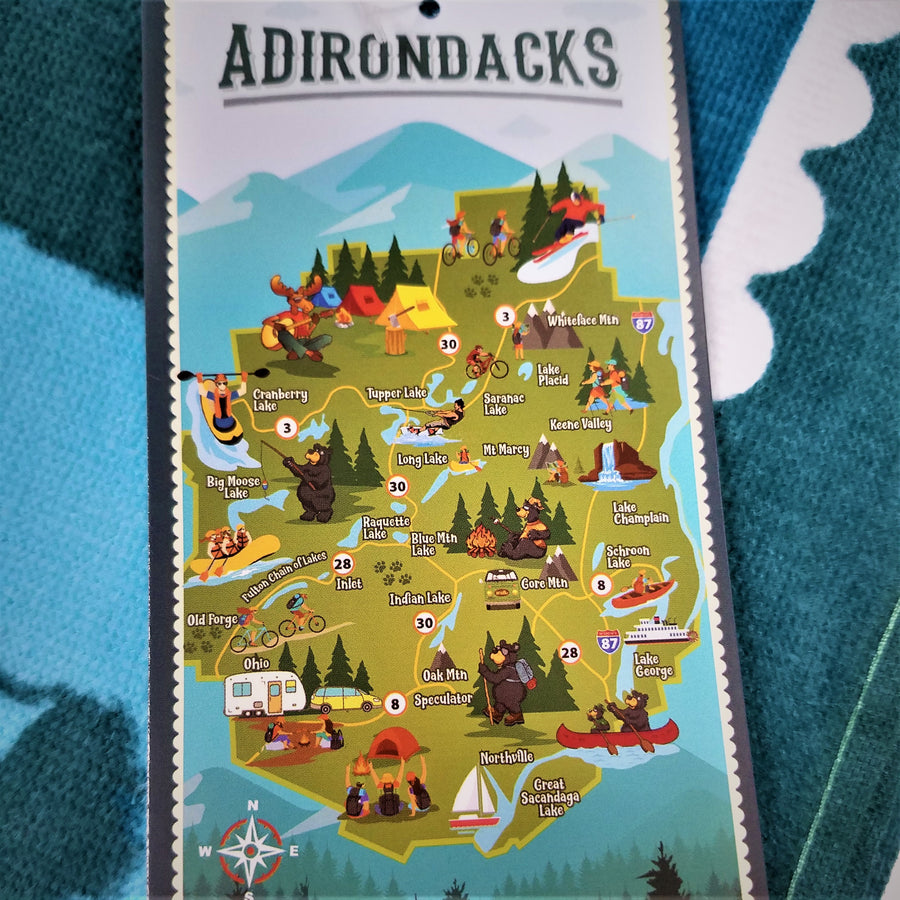 Vertical promotion card with the full-color map of the park and its attractions atop the actual terry cloth towel.