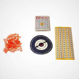 Game pieces left to right: red translucent chips, Bingo number spinner under Bingo cards.  Rectangular Bingo number board.