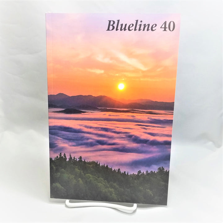 Cover of Blueline 40 book featuring a sunset over purple mountains and water with an evergreen foreground