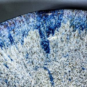 Close-up o blue glaze on edge of ceramic bowl