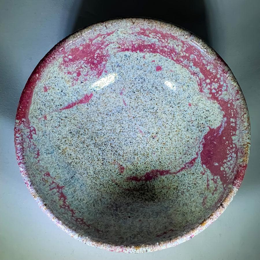 Inside view of ceramic bowl. Rose speckled glaze on inner edge of inside rim with pale green speckled glaze inside bowl