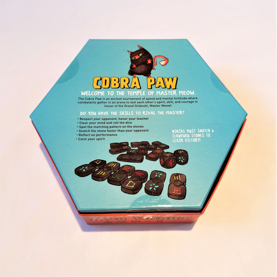 Back of Cobra Paw game box with a short description of the game and some rules. Also illustrations of the pieces inside. 