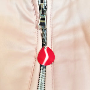 Zipper with red and white spinner lure attached.