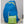 Blue back back opened up for display behind the green packaging of a folded backpack.