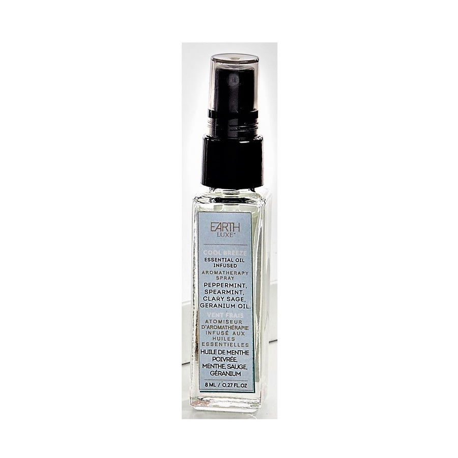 Single glass bottle of Earth Luxe Cool Breeze Aromatherapy spray standing upright. The top has a black spray dispenser seen through its plastic cover. A pale blue vertical product label fills the front side of the bottle.