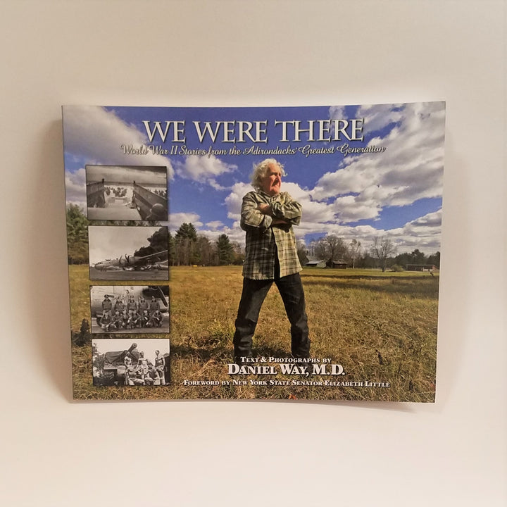 Cover of book We Were There featuring a full-color photo with white-haired gentleman in a field facing out. Four b/w WWII photos are inset to the left under the title and next to the man.